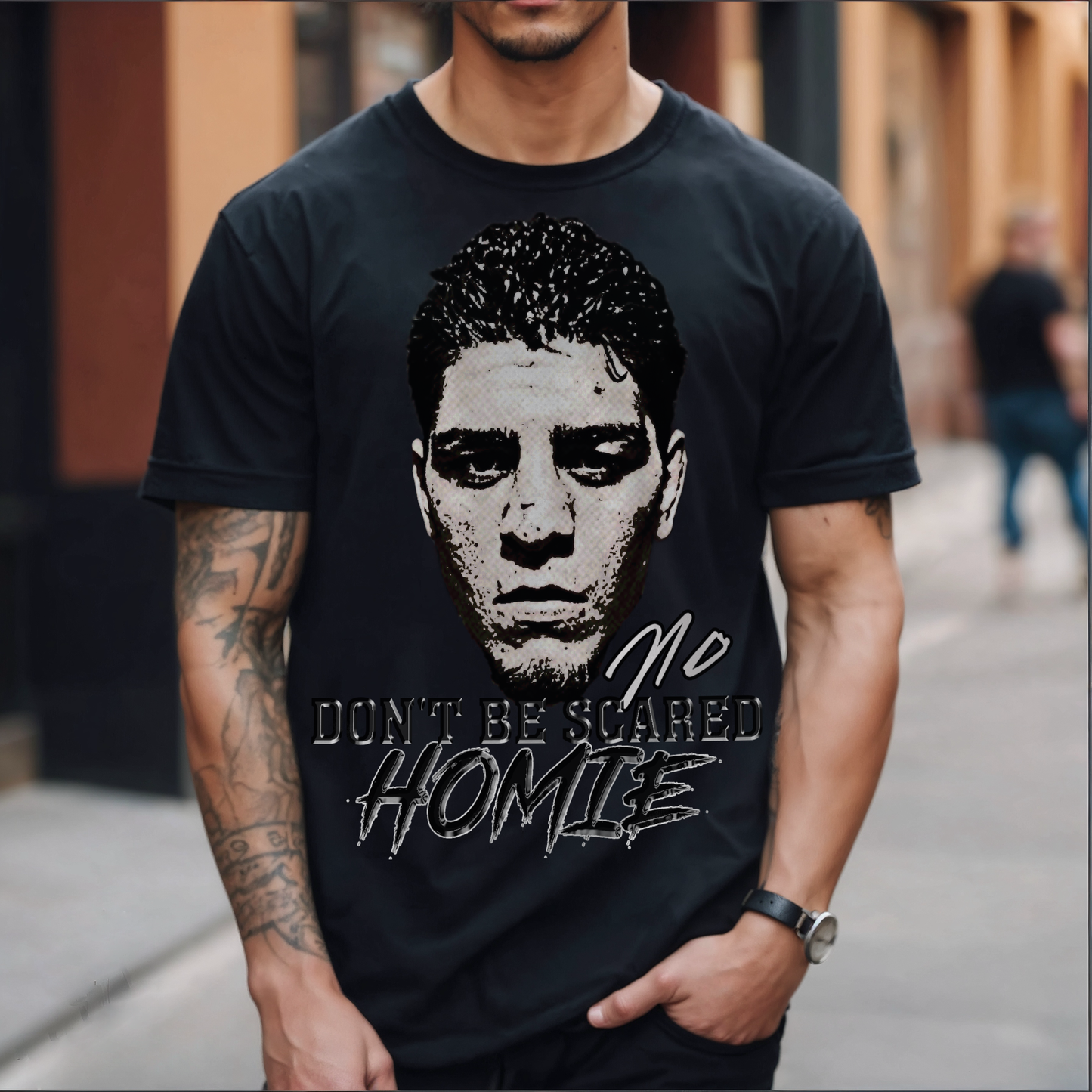 Front view image: Alt text: Front view of the Kings Origin Nick Diaz “Don’t Be Scared Homie” heavyweight black t-shirt.
Detail image: Alt text: Close-up of the big-face graphic on the Kings Origin Nick Diaz t-shirt.
Model image: Alt text: Male model wearing the Kings Origin Nick Diaz t-shirt.