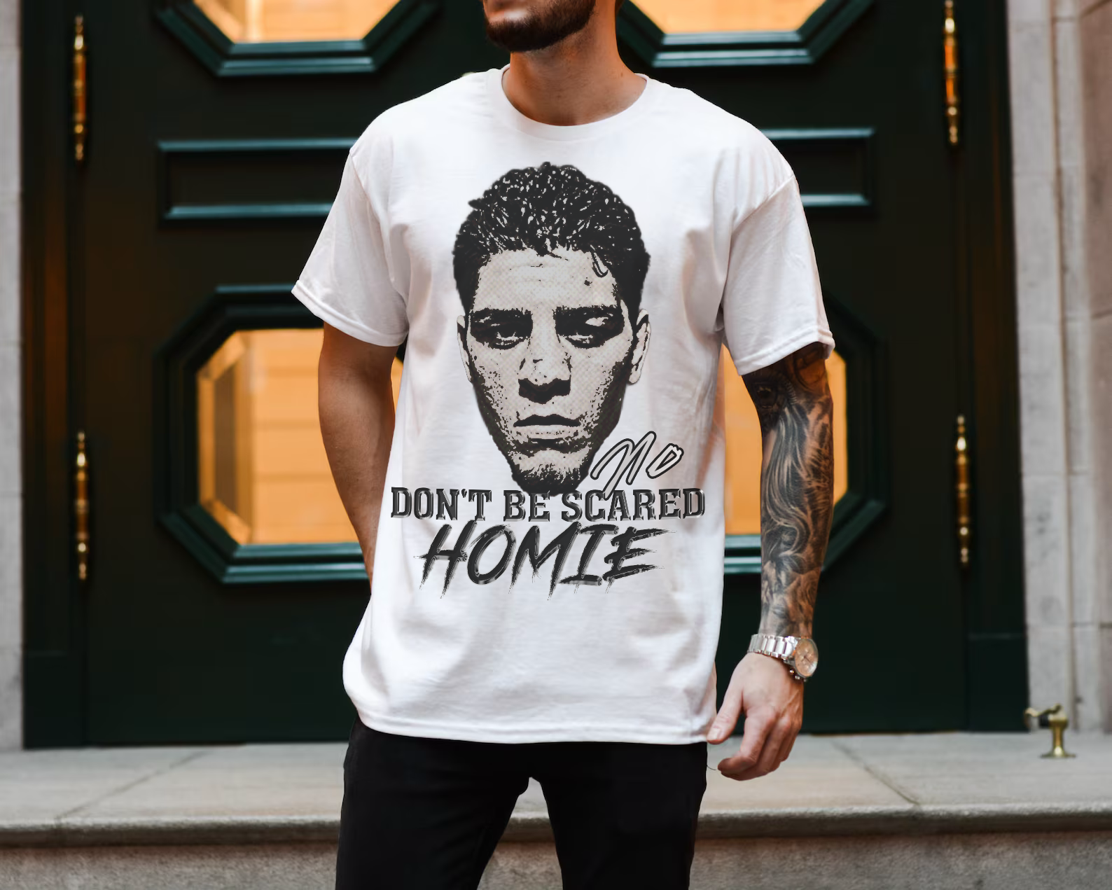 Front view image: Alt text: Front view of the Kings Origin Nick Diaz “Don’t Be Scared Homie” heavyweight black t-shirt.

Detail image: Alt text: Close-up of the big-face graphic on the Kings Origin Nick Diaz t-shirt.

Model image: Alt text: Male model wearing the Kings Origin Nick Diaz t-shirt.